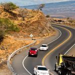 Cars navigate the Pali Highway around the cliffs of West Maui.